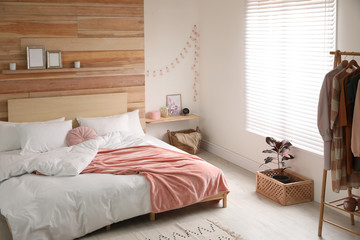 Fototapeta na wymiar Stylish room interior with big comfortable bed