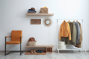 Hallway interior with stylish furniture, clothes and accessories