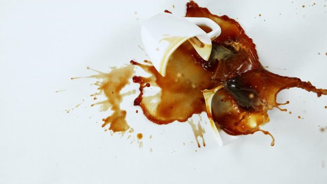 Super Slow Motion Shot of Breaking Coffee Cup on White Cloth at 1000fps.