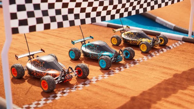 Three colourful RC-cars standing on a start line, ready for a toy race. 4KHD