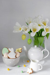 Easter table setting with gingerbread bunnies, eggs and flowers. Happy Easter Greeting Card Template.