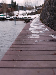 Light snow on a wooden dock at the Lake Joux or Lac de Joux in Switzerland.