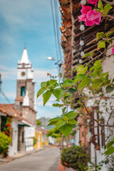 Fototapeta na wymiar a colorful street in with a church in Honda, Colombia