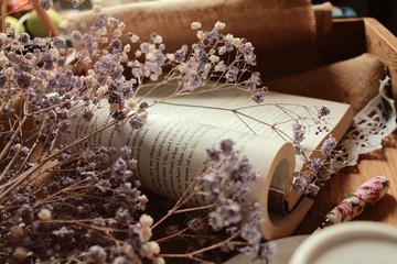 Closeup shot of beautiful dried flowers on an open book