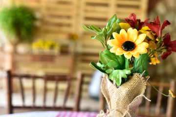 beautiful decorative arrangement of natural flowers on the table on blurred background