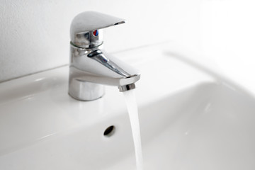 running water tap at a wash basin, hygiene and hand washing is an important preventive measure...