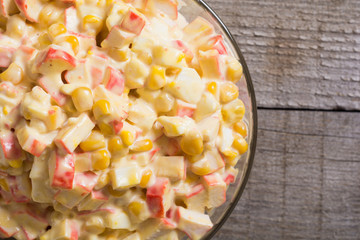 Salad with crab sticks , corn , eggs and mayonnaise