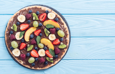 Fruit pizza with nut nougat cream , fruit and berries