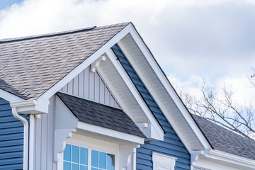 Elegant American house facade, with Shed Roof Over Awning Window, double gable white brackets, gray...