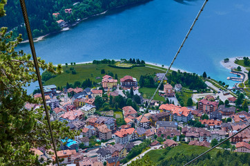Aerial view over the beautiful Molveno town and Molveno lake, an alpine lake in Trentino, Italy