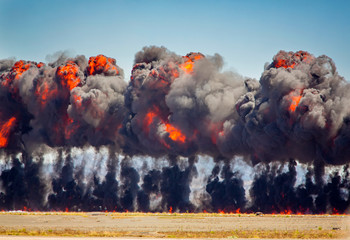 Line of explosive fire and smoke from munitions