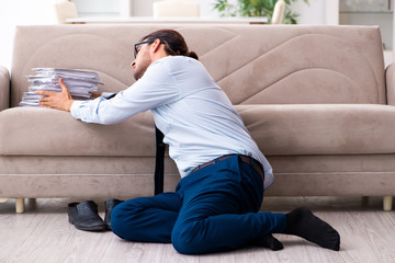 Young male businessman working at home
