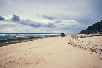   Ocean coast line at the Bali, Indonesia with cloudy sky