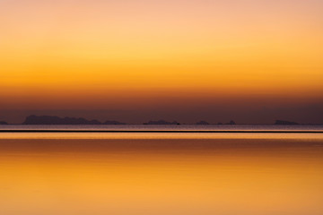 Beautiful sunset over the sea water on the island of Koh Phangan, Thailand. Travel and nature concept