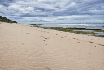   Ocean coast line at the Bali, Indonesia with cloudy sky