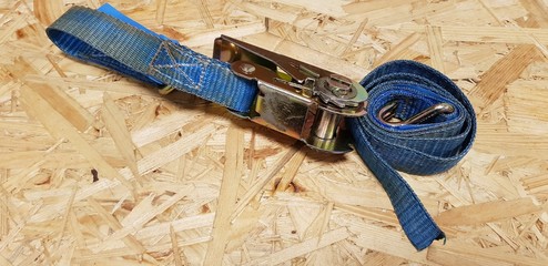 ratchet strap on wooden background