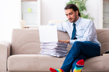 Young male businessman working at home