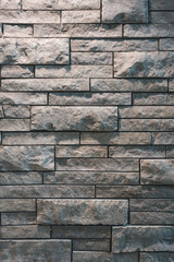 Grey Stone Wall Texture with Bricks of Different sizes meshing together for unique tile pattern