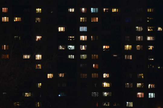 Apartment building at night. People staying at home
