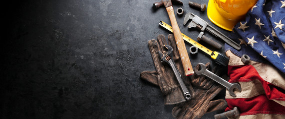 Construction and manufacturing tools with patriotic US, USA, American flag on dark black background
