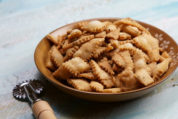 Namakpara (Khurma, Nimki, Mathri) which is a crispy, crunchy and savory strips in a bowl.