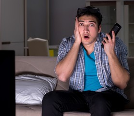 Fototapeta premium Man watching 3d television late at night