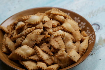 Namakpara (Khurma, Nimki, Mathri) which is a crispy, crunchy and savory strips in a bowl.