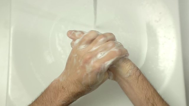 Top view close up of Man washing hands in slow motion