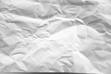 white and gray crumpled paper texture background. crush paper so that it becomes creased and wrinkled.