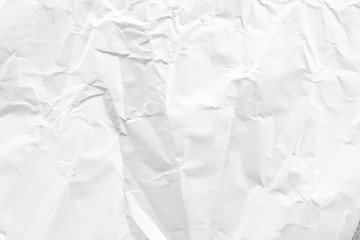 white and gray crumpled paper texture background. crush paper so that it becomes creased and...