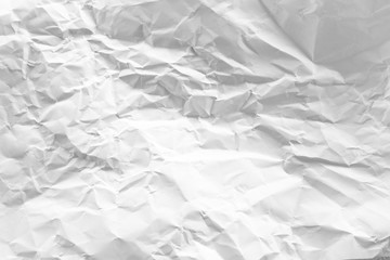 white and gray crumpled paper texture background. crush paper so that it becomes creased and...