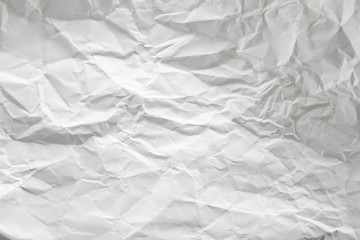 white and gray crumpled paper texture background. crush paper so that it becomes creased and...