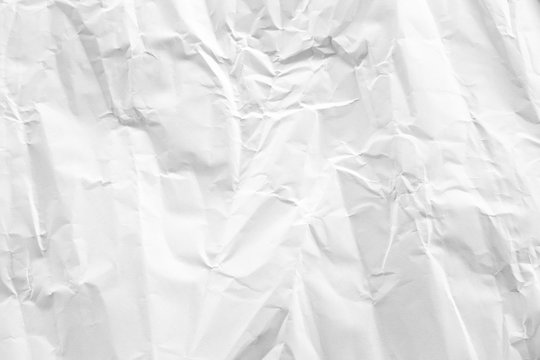 white and gray crumpled paper texture background. crush paper so that it becomes creased and wrinkled.