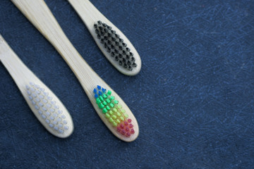 wooden tooth brush on black background, top view 