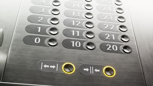 Modern, shiny, metallic elevator buttons illuminated by bright light. 4KHD