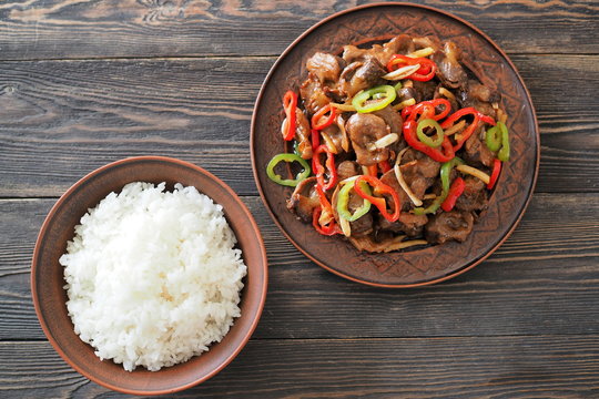 Chicken gizzard with chili peppers and boiled rice. Chinese cuisine. Top view.