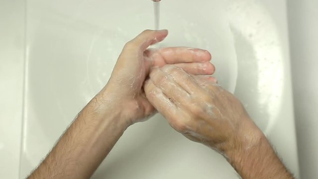 Top view close up of Man washing hands in slow motion