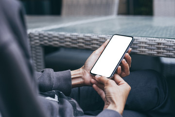 Mockup image blank white screen cell phone.woman hand holding texting using mobile on desk at coffee shop.background empty space for advertise text.people contact marketing business,technology