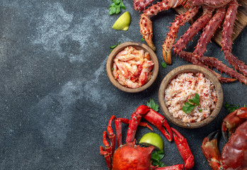 Crabs seafood background with crabs selections and crab meat on black background © lblinova