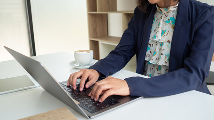 Two business women are working on financial charts, making business growth, developing business