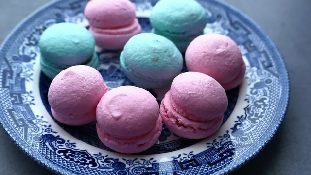 close up of color macaroon on plate on table 