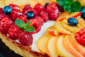 Classic simple new York cheesecake with berries and fruit, close-up view, selective focus