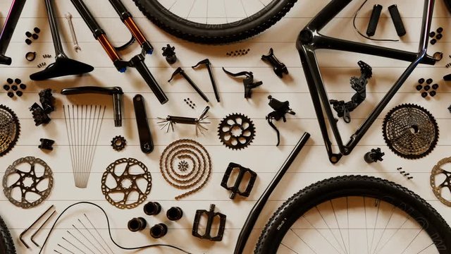 Bike components composed at garage workbench. Endless animation. Top view. 4k HD