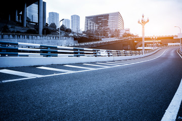 Road surface and urban building skyline..