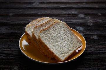 Fresh homemade  baked bread and sliced bread on wooden