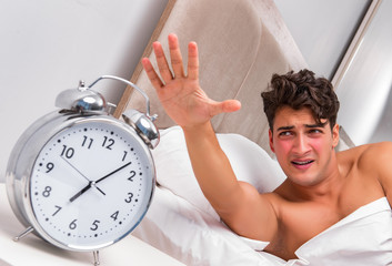 Man having trouble waking up in the morning