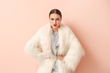 Beautiful young woman on color background