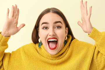 Happy young woman on light background