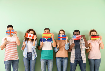 Young students of language school on color background