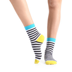 Legs of young woman in socks on white background